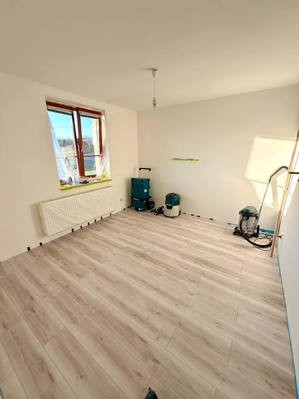 Průběh prací v pokoji s nářadím a připravenými stěnami